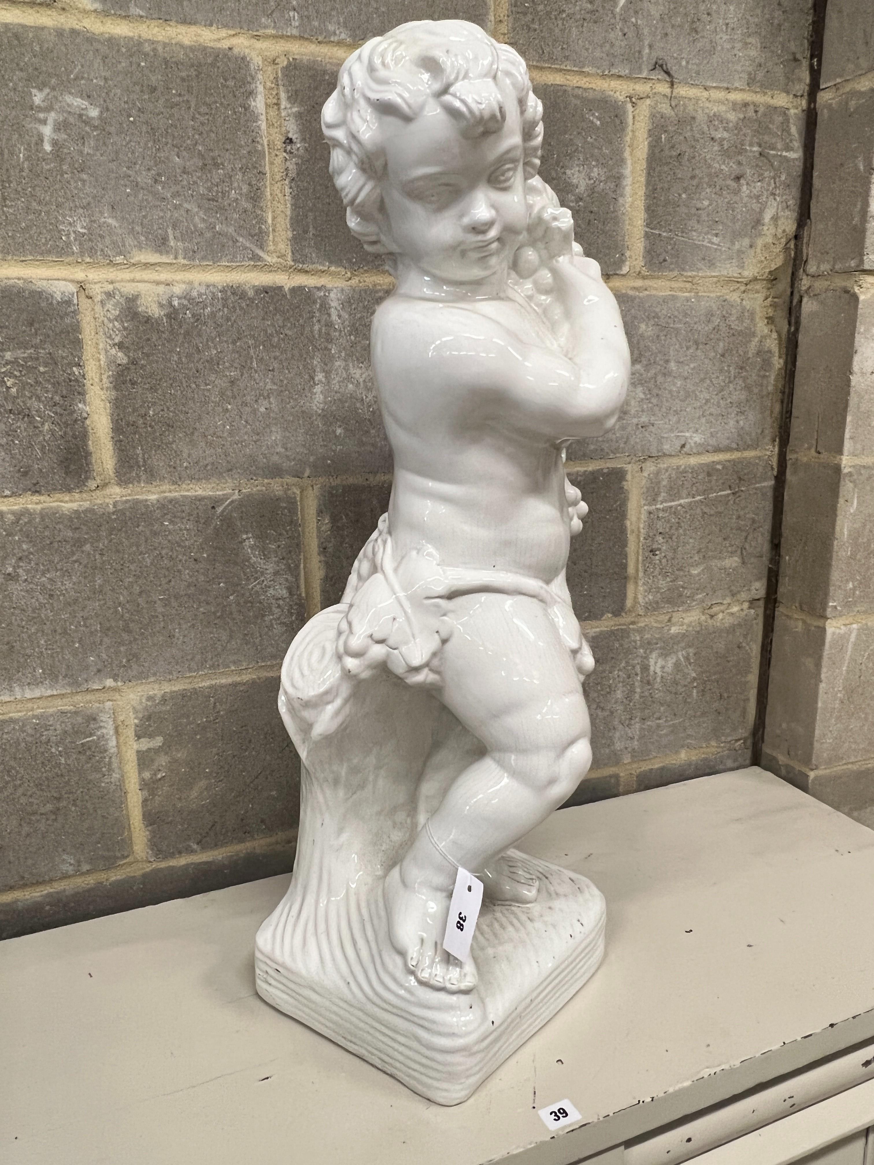 A glazed earthenware cherub ornament, height 87cm